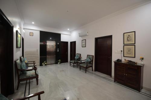 a living room with two chairs and a table at Jai Villa - A Boutique Hotel in Jaipur