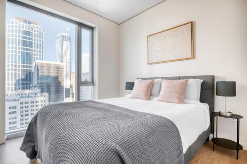 a bedroom with a bed with a large window at Downtown 2br w Gym wd BBQ nr dining shops SEA-402 in Seattle