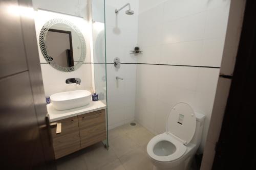 a bathroom with a toilet and a sink and a mirror at Jai Villa - A Boutique Hotel in Jaipur