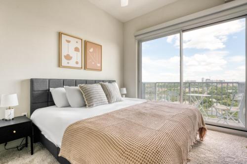 a bedroom with a large bed and a large window at Downtown 1br w gym wd pool nr Capitol ATX-83 in Austin