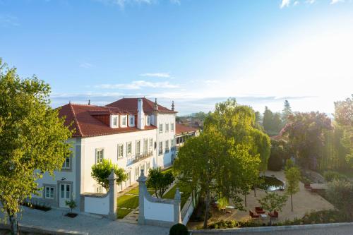 a large white house with a red roof at Valverde Santar Hotel & SPA - Relais & Châteaux in Santar