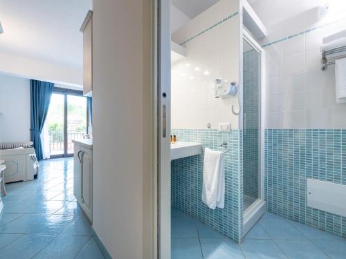 a bathroom with a sink and a shower at Green Village Resort in Villasimius