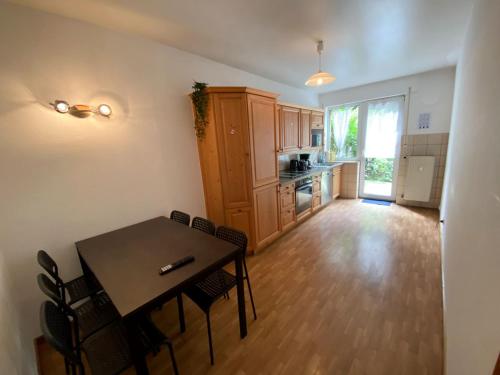 a kitchen and dining room with a table and chairs at Cozy Apartment in Oberhausen in Oberhausen