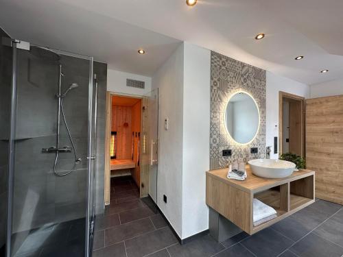 a bathroom with a sink and a shower at Ferienhaus Waldschatz Baiersbronn in Baiersbronn