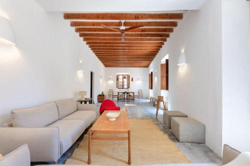 a living room with a couch and a table at El Convento de Biniamar in El Port de la Selva