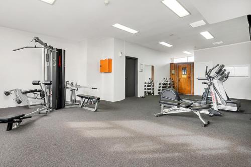 a gym with several exercise equipment in a room at Contemporary Apartment in Sydney