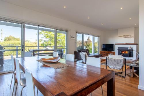 a dining room with a table and a living room at Nikabel Beach House I Private Properties in Dunsborough