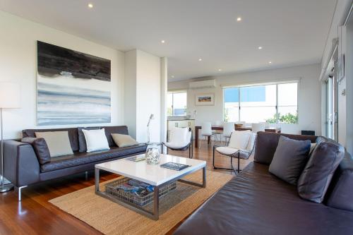 a living room with a couch and a table at Nikabel Beach House I Private Properties in Dunsborough