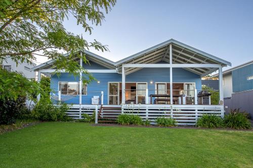 a blue house with a white porch at Nikabel Beach House I Private Properties in Dunsborough