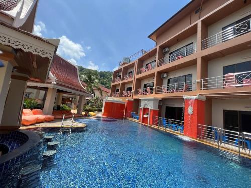 a swimming pool in front of a hotel at My Friend's House Villa in Karon Beach