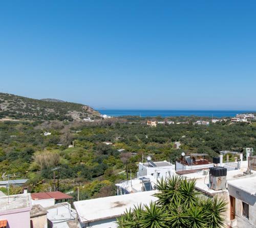 a view of a town with the ocean in the background at Jasmine Summer House in Kalo Chorio