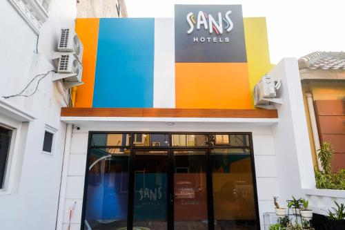 a store front with a colorful sign on it at Sans Hotel City Park Medoho Semarang in Alastuwo