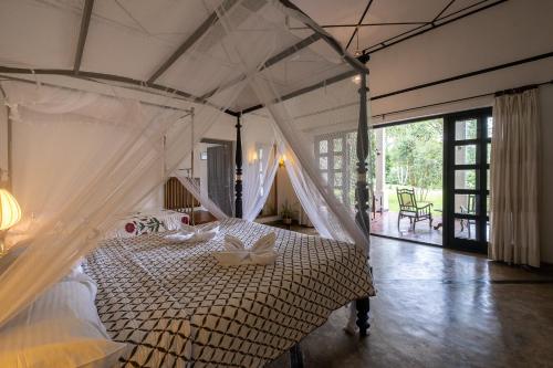 a bedroom with a bed with a bow on it at Horathapola Estate in Marawila