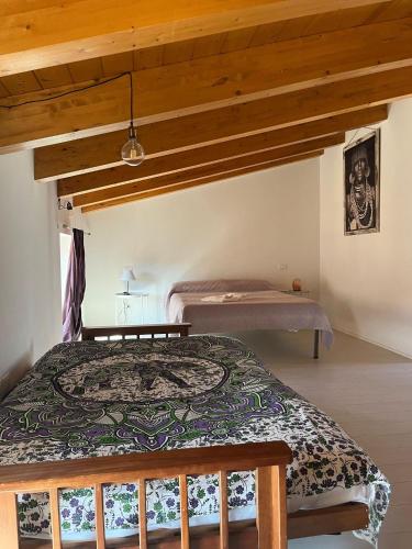 a bedroom with a bed in a room with wooden ceilings at B&B MAMAOH in Fondi