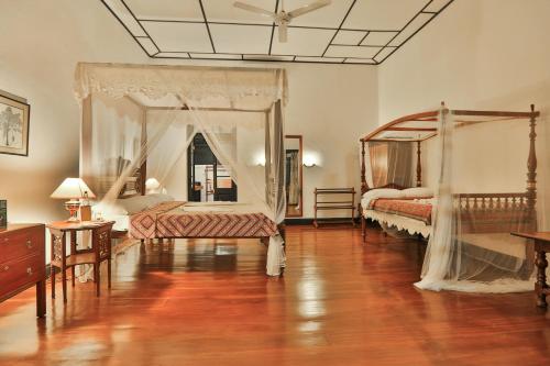 a bedroom with two beds and a ceiling at Horathapola Estate in Marawila