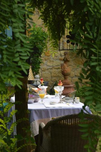 a table with wine glasses on top of it at La Rebière d'Or, B&B et Gîte in Mouleydier