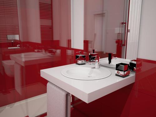 a bathroom with a white sink and two mirrors at Roma Resort Colosseum in Rome