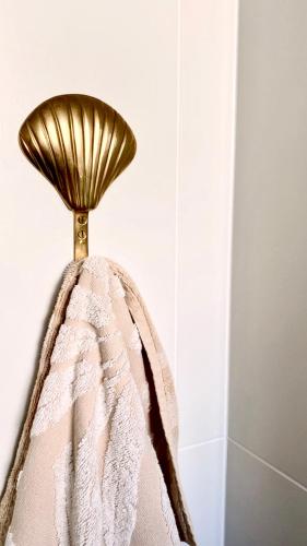 a gold lamp sitting on top of a towel at The Villa's Mooloolaba in Mooloolaba