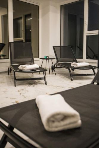 two black chairs with white towels on them in a room at Klečka vila B&B rooms in Ogulin