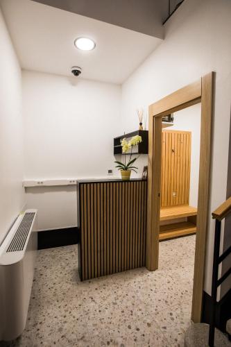 a room with a desk and a bench and a door at Klečka vila B&B rooms in Ogulin