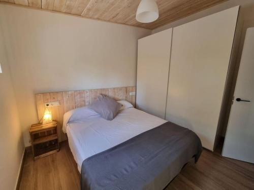 une chambre avec un lit et une table de chevet avec une lampe dans l'établissement Cal Masses , St. Salvador de Guardiola, à Guardiola