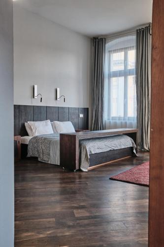 a bedroom with two beds and a large window at Hotel Monopol in Wrocław
