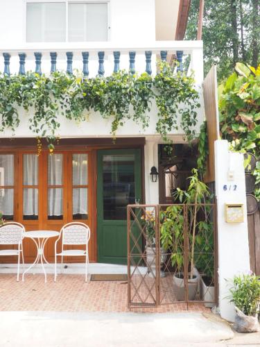 a front porch of a house with a green door at Cozy House in Middle of Old Town Chiangmai in Chiang Mai
