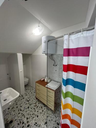 a bathroom with a colorful shower curtain and a sink at Ada in Zadar