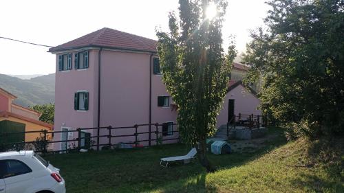 a white house with a bench in the yard at LA TANA DELLA VOLPETTA - Bed & Breakfast in Stella