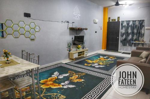 a living room with a couch and a table at lumut manjung homestay john faten in Lumut