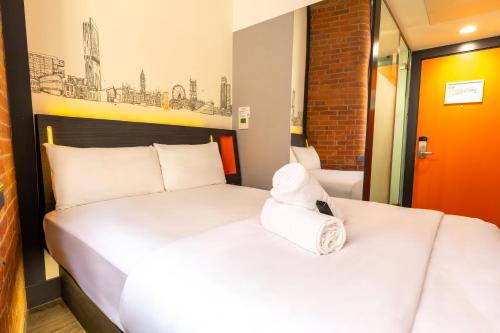 a hotel room with two beds in a room at easyHotel Manchester in Manchester