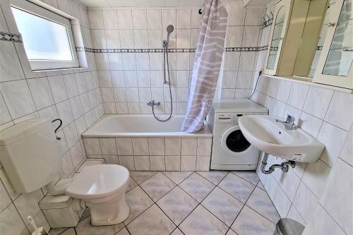 a bathroom with a toilet and a sink and a tub at Apartment with Roof-Top in Düren in Düren - Eifel