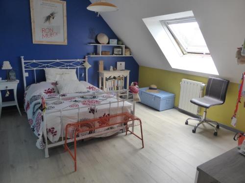 a blue bedroom with a bed and a chair at LA MARNE TRANQUILLE in Le Perreux-Sur-Marne