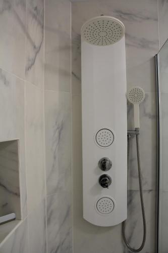a shower with a shower head in a bathroom at Favoloso trilocale a Las Americas in Arona