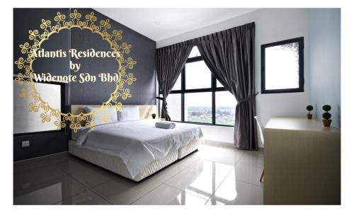 a bedroom with a bed with a sign on the wall at Atlantis Residence - Widenote Sdn Bhd in Melaka