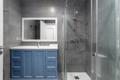 a bathroom with a blue cabinet and a shower at House Riberas in Loyola