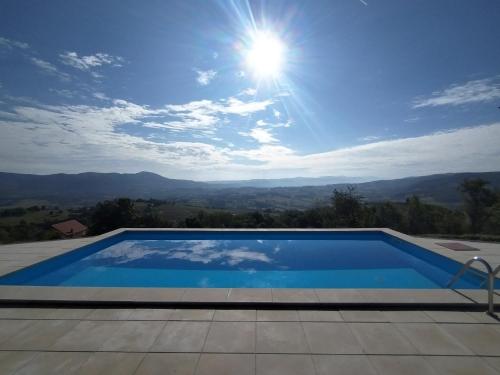 a swimming pool with a view of the mountains at Villa Vista in Banja Luka