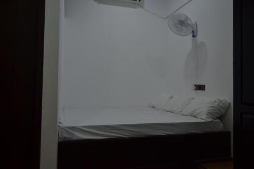 a small bed in a room with a window at BW Residence in Kalmunai