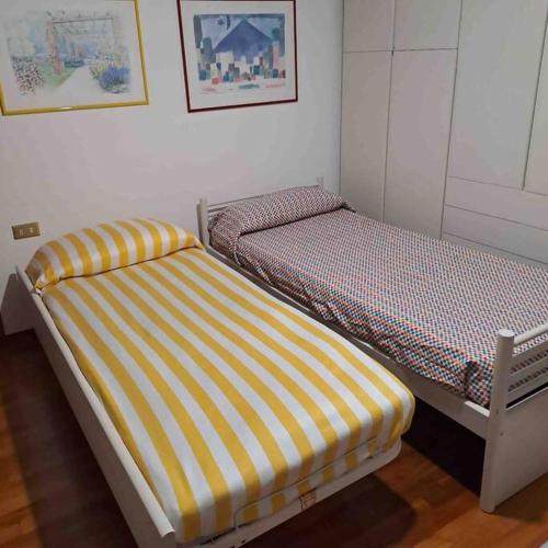 two beds sitting next to each other in a room at A casa di Gianni in Gallarate