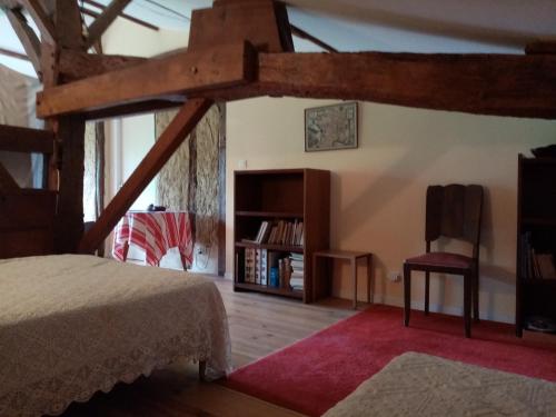 a bedroom with a bed and a book shelf at Ricouch, chambre d'hôtes et permaculture in Momuy