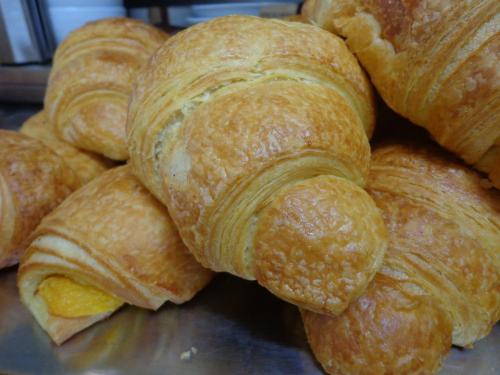 a pile of croissants sitting on top of a table at Casa João Chagas Guesthouse, Constância in Constância