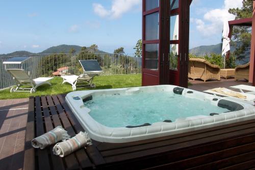a hot tub sitting on top of a patio at Luxury Easy Living in Framura in Framura