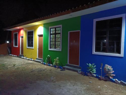 a house with colorful doors and windows at night at The Marak Village KB - Mini Homestay in Kota Bharu