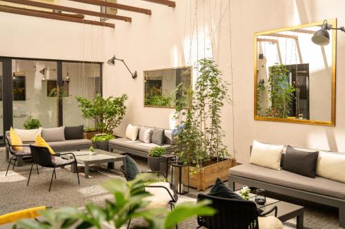 a living room with couches and tables and plants at INNSiDE by Meliá Prague Old Town in Prague