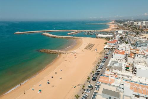 an aerial view of a beach and the ocean at Orange Boutique Residence - Casa Diogo in Quarteira