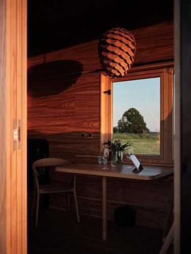 a small table in a room with a window at Glamping Na Malém Háji in Hora Svaté Kateřiny