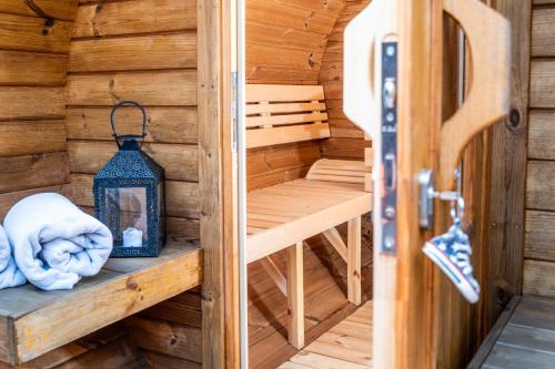 a sauna in a wooden cabin with a lantern at Harley in der Heide in Buchholz Aller