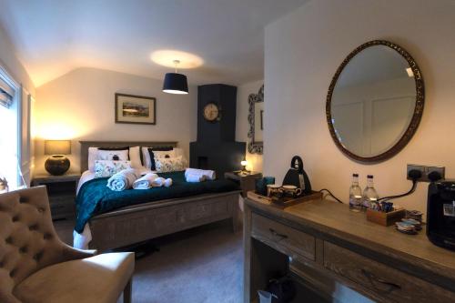 a bedroom with a bed with a large mirror at The Clockhouse Bewdley in Bewdley