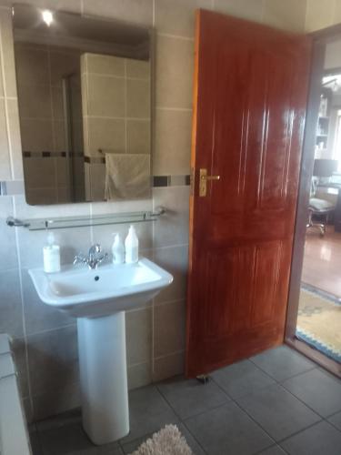 a bathroom with a sink and a mirror at Room2rent Centurion in Pretoria