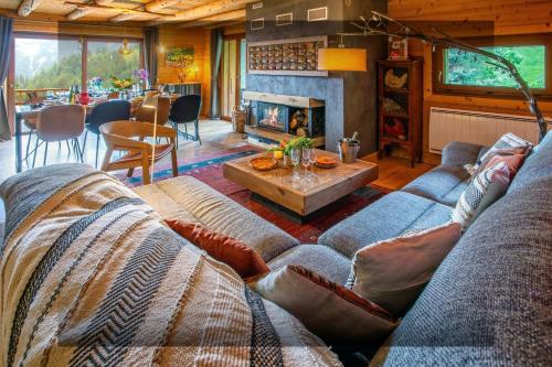 a living room with a couch and a fireplace at Chalet Bendo - OVO Network in Villarembert